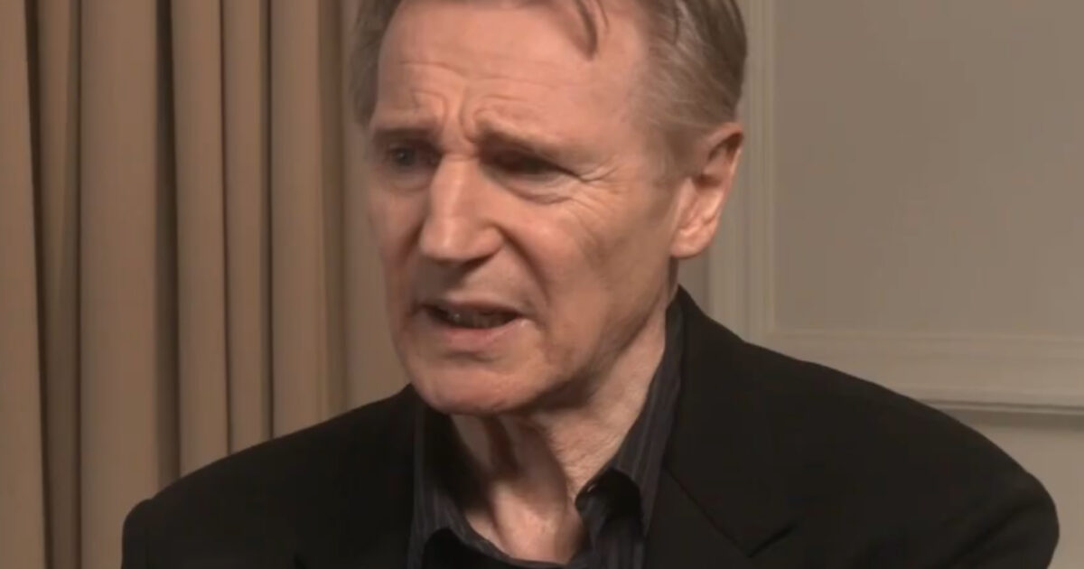 Close-up of a male actor expressing concern during an interview, wearing a black jacket against a neutral background.