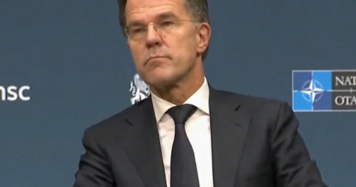 Mark Rutte, Prime Minister of the Netherlands, attends a press conference at the NATO summit, displaying a thoughtful expression against a backdrop of NATO branding.