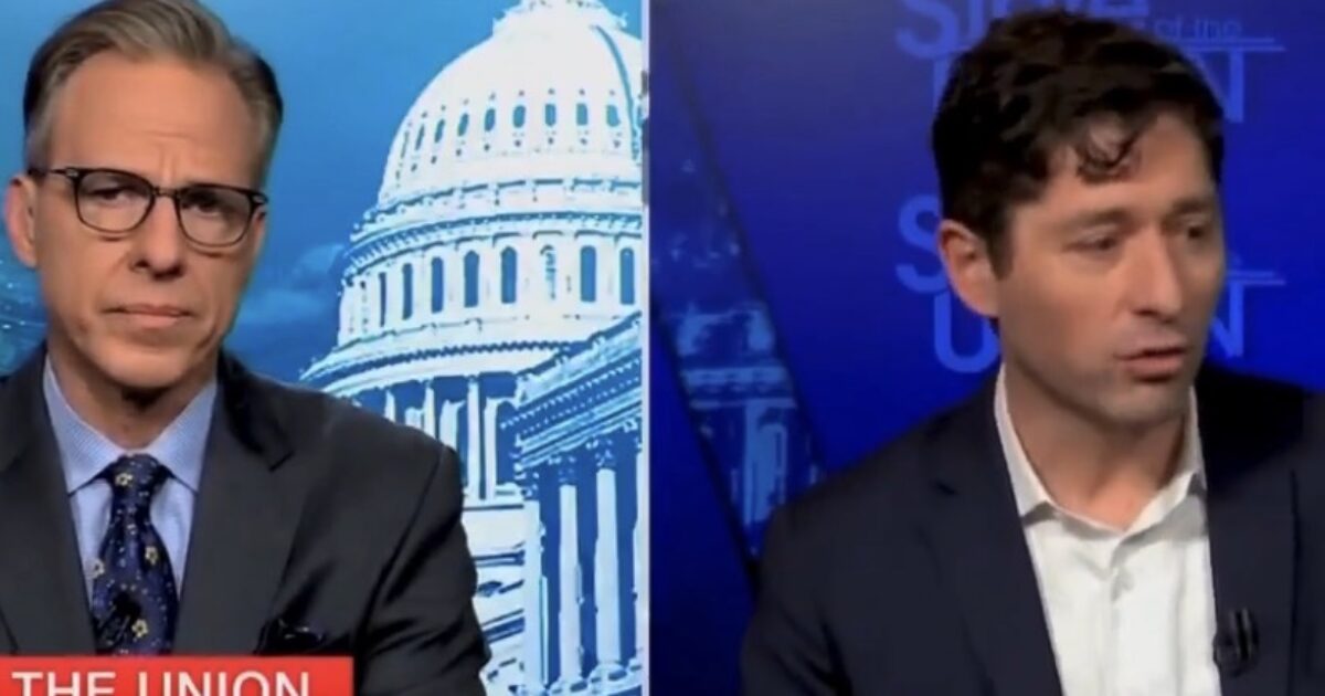 News interview featuring two men discussing political topics, with the U.S. Capitol building in the background and a graphic displaying "State of the Union."