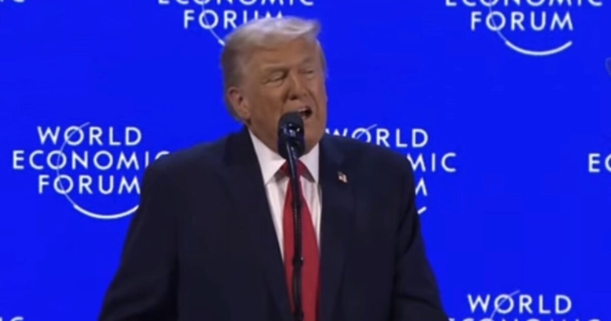 Donald Trump speaking at the World Economic Forum, emphasizing key global economic issues against a blue backdrop with the forum's logo.