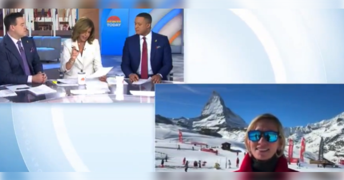 Television hosts discussing a winter sports event with a snowy mountain backdrop featuring a smiling guest wearing sunglasses.