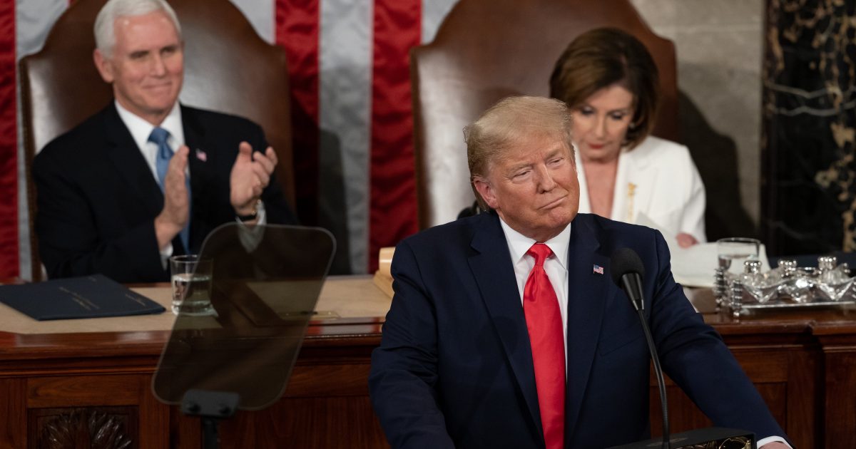 Donald Trump delivers a speech before Congress, flanked by Mike Pence and Nancy Pelosi, with an American flag backdrop.