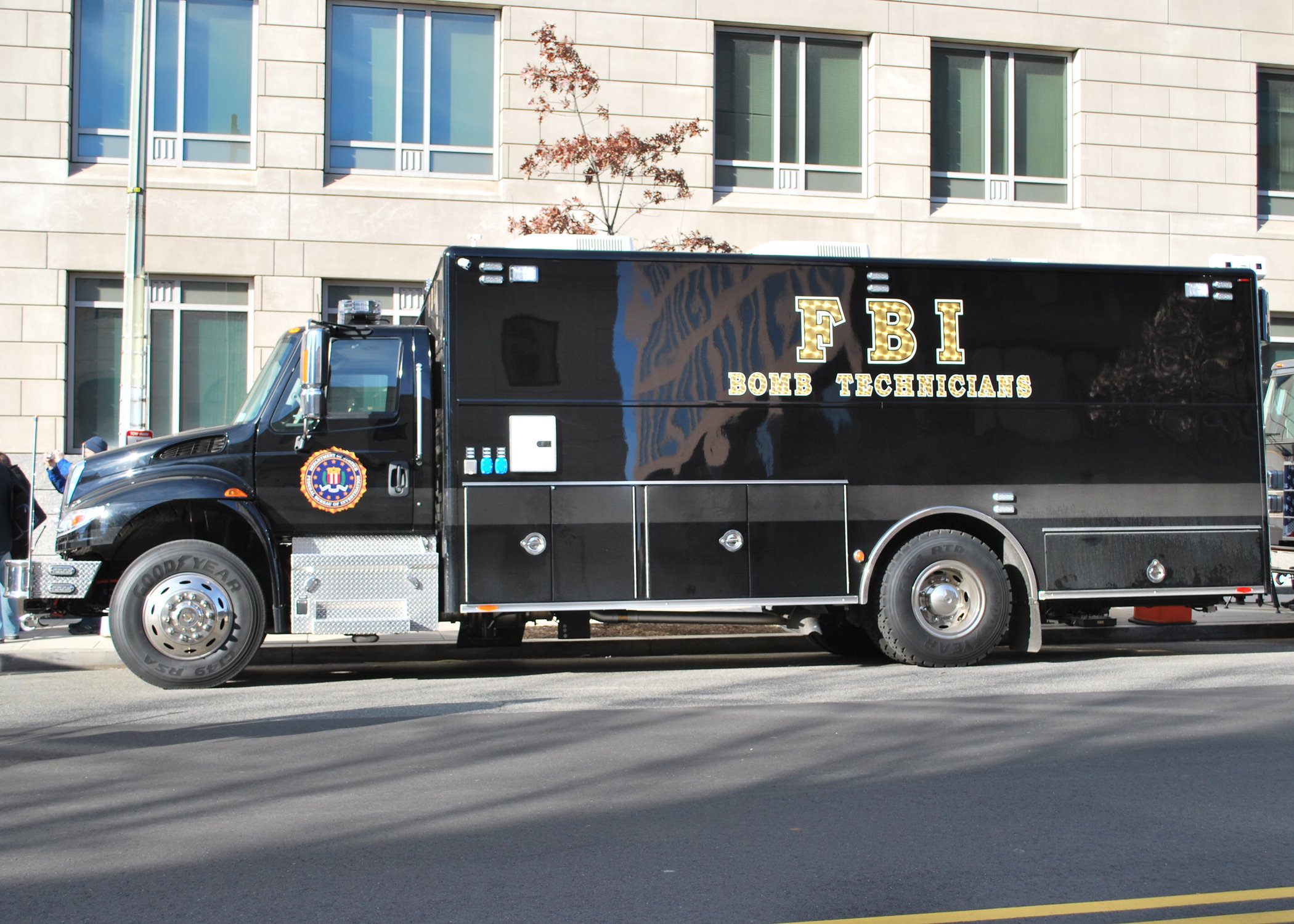 FBI bomb technician vehicle parked on the street, showcasing its black exterior and official markings.
