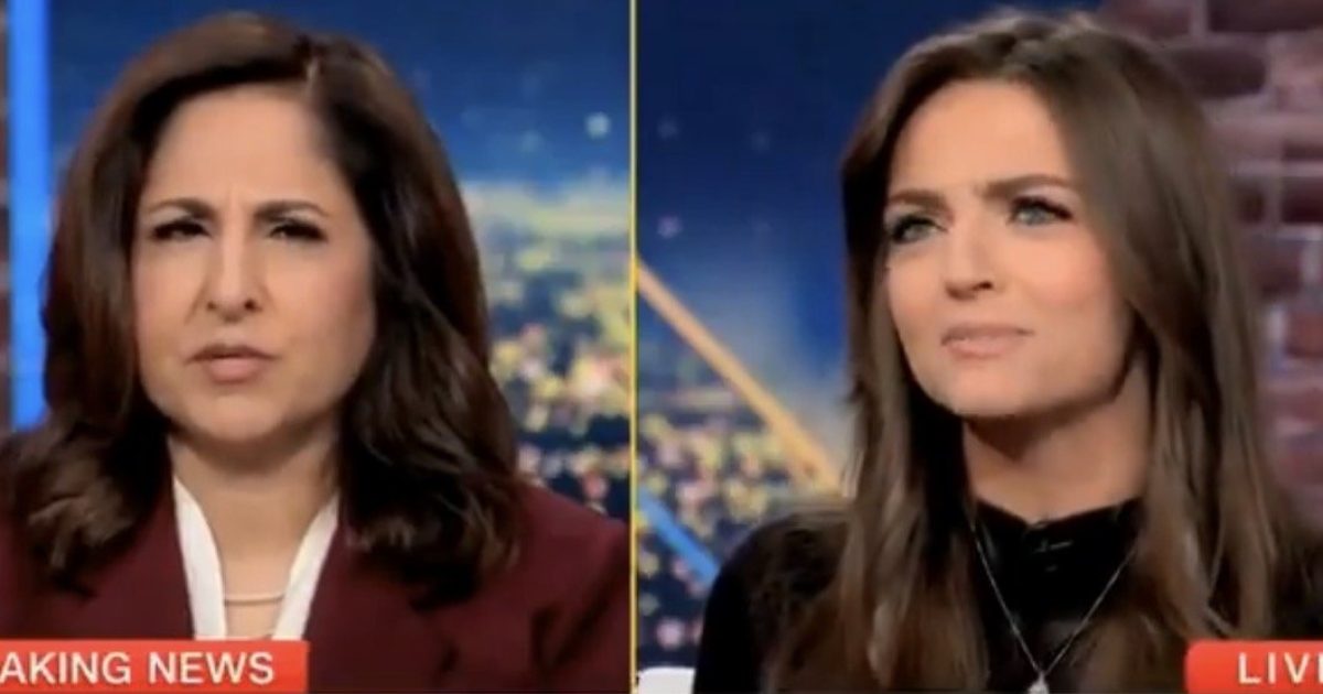 Two female news anchors discussing breaking news on a television broadcast, with a city skyline visible in the background.