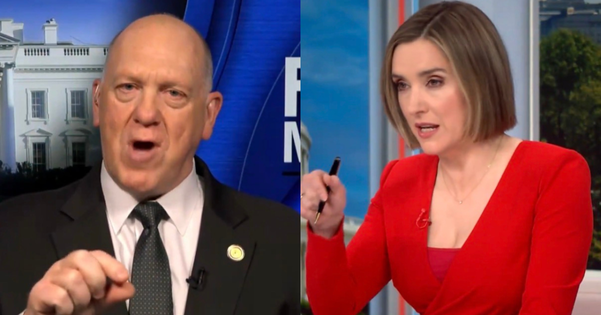 Two news anchors engaged in a discussion, with one gesturing emphatically and the other taking notes, set against a backdrop of the White House.