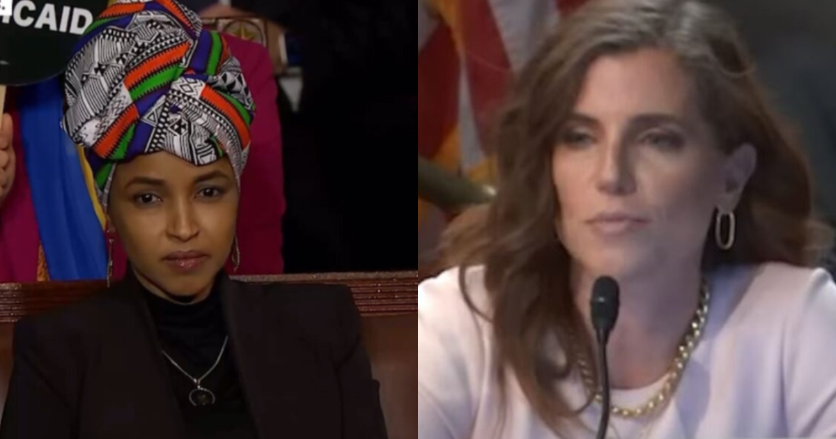 Two women in a legislative setting, one wearing a colorful headwrap and the other speaking into a microphone, highlighting political discourse and representation.