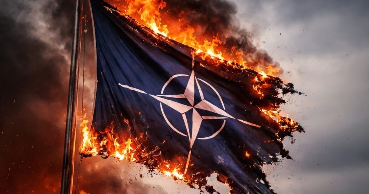 NATO flag engulfed in flames against a dramatic sky, symbolizing conflict and protest.