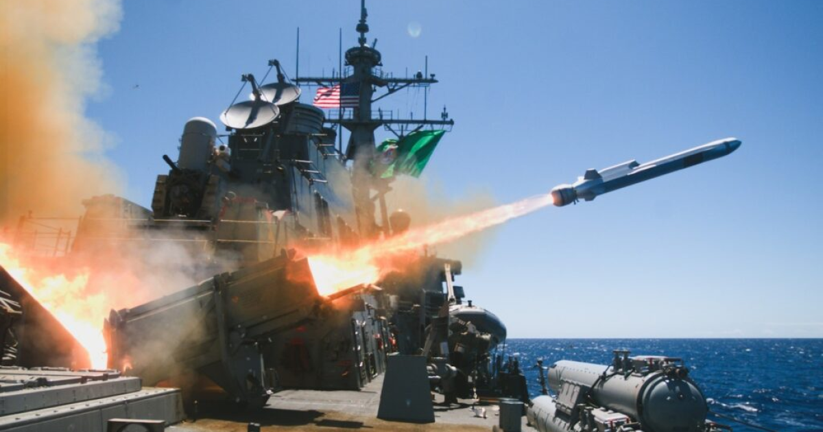 Missile launch from a naval warship, showcasing military technology and operations at sea against a clear blue sky.