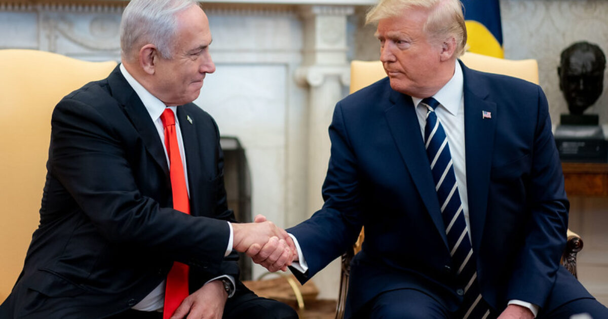 Israeli Prime Minister Benjamin Netanyahu and former U.S. President Donald Trump shake hands in the Oval Office during a diplomatic meeting.